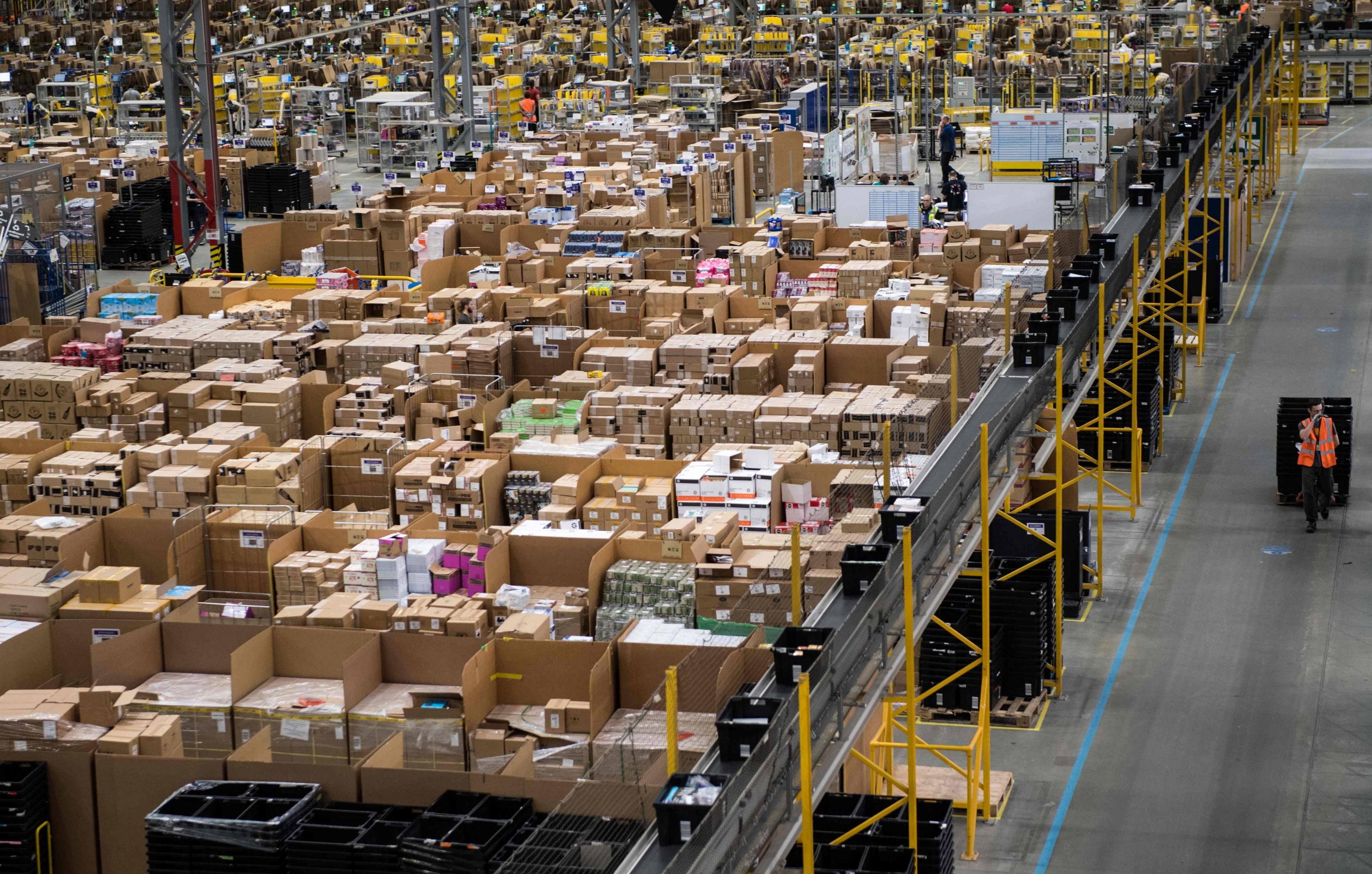 Los trabajadores de Amazon preparan los pedidos de los clientes para su envío. (Foto: AFP)